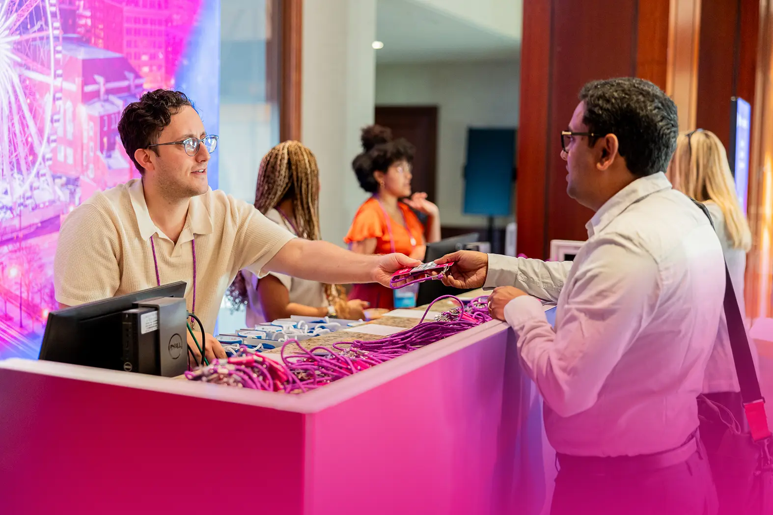 eventguru-b2b-event-onference-attendee-picking -up-a-name-badge